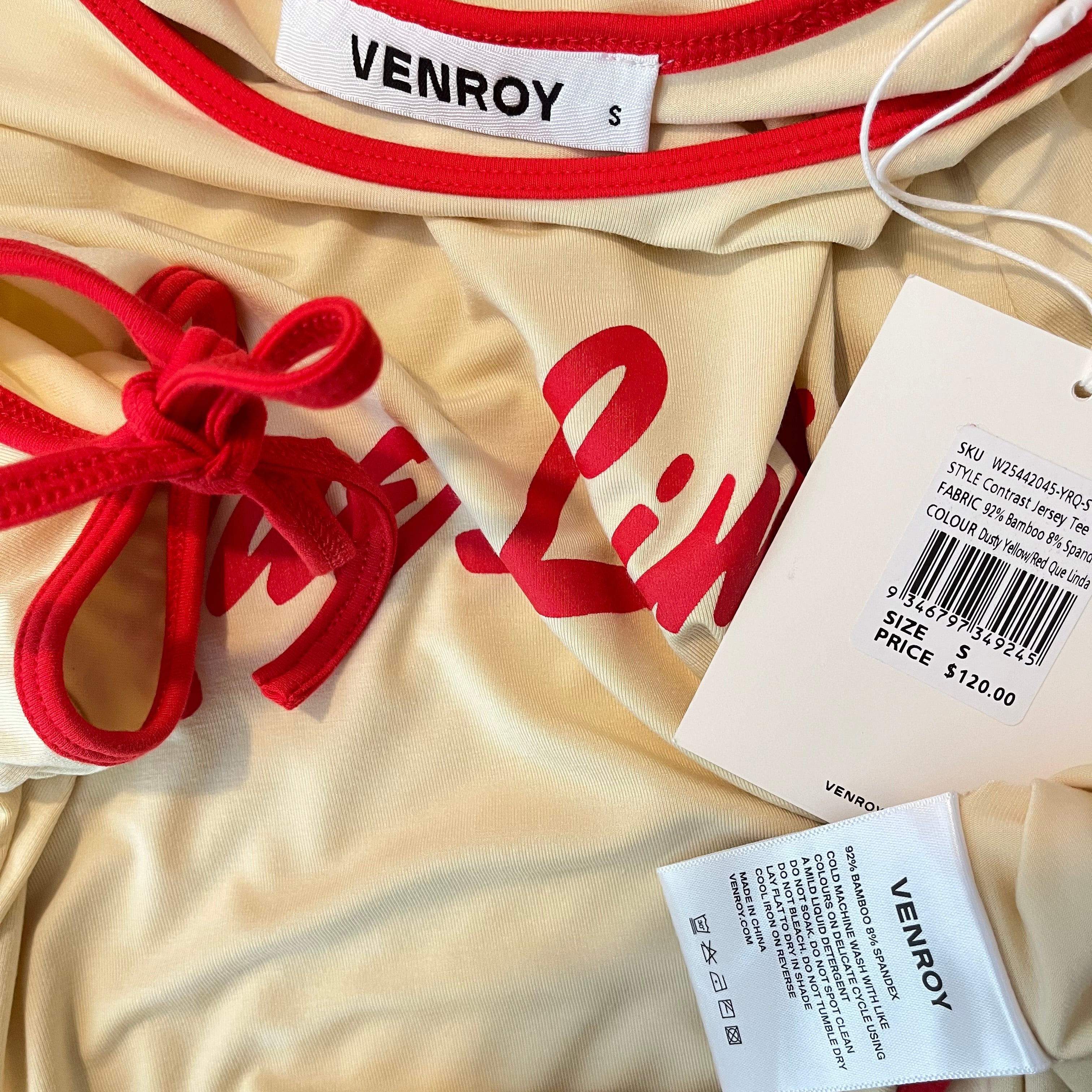 Beige garment with red accents and 'VENROY' labels on a beige background
